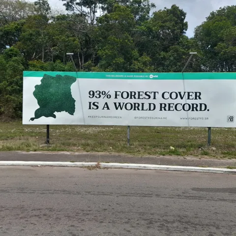 The campaign billboard at the International Airport of Suriname, reading "93% forest cover is a world record"