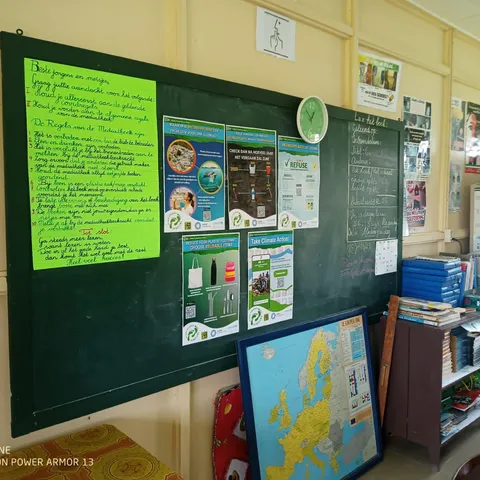A classroom blackboard with the workshop notes and posters on it
