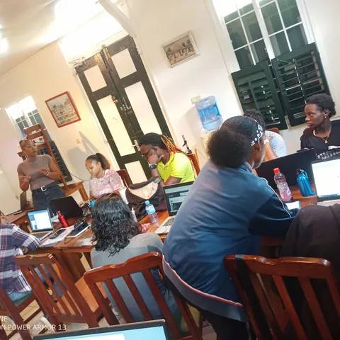 Participants seated around tables during an indoor awareness session