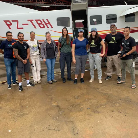 The ambassadors and their companions lined up in front of the small plane that flew them south