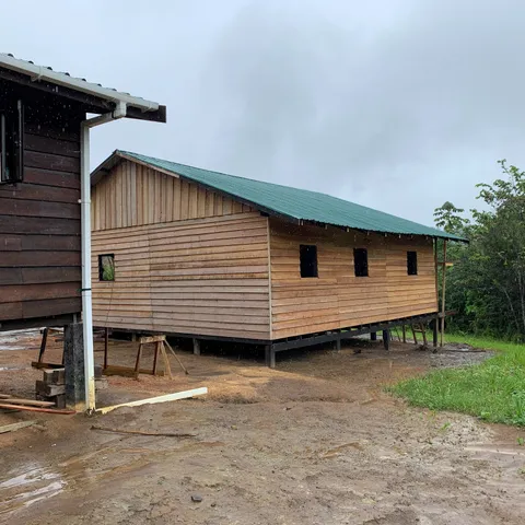The new timber warehouse on stilts next to the enterprise building, seen in the rain